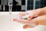 Detail of little girl washing her hands